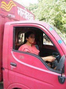 Tulsi Tewari driving the red-colored mini truck that carries mails from all over the world to small hill towns. Photo by Rakesh Agrawal.