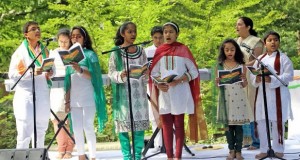 Children from the Gandharva School of Music in Richmond, VA, sing patriotic songs at the Indian Independence Day celebrations at the Embassy Residence in Washington, DC, Thursday. School Director Nirmal Bajekal is also seen.
