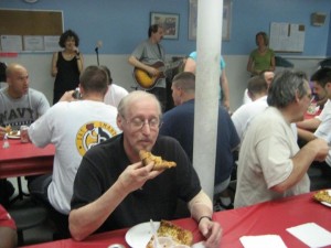 A Slice of Hope pizza party in Vegas, with live musician in background