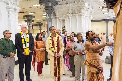 A Hindu priest performs Puja at the Sri Siva Vishnu Temple in Maryland on April 3, 2014. Looking on in the foreground from left to right are: Shekar Narasimhan, an appointee to President Obama’s Advisory Commission on Asian Americans and Pacific Islanders,: Congressman Joseph Crowley; Dr. Alice Chen, Executive Director of Doctors For America; and Dr. Vivek Murthy, President Obama’s nominee for US Surgeon General. Photo by Geeta Goindi