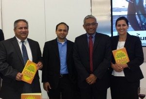 Ravi Venkatesan (second from right) poses for a photo after signing copies of his book.