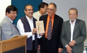 N. K. Mishra showing a copy the book "The Treasure: A Modern Rendition of Ghalib’s Love Poetry" by Surinder Deol.