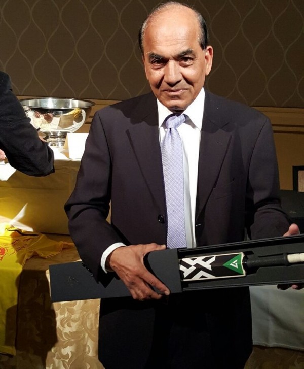 Hotelier Raj Parikh with a cricket bat that will auctioned.