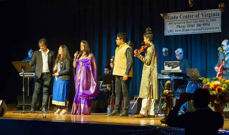 Kavita Krishnamurthy (center) performing in Richmond on March 20, 2016. Her son Ambi Subramaniam is on violin on the right.