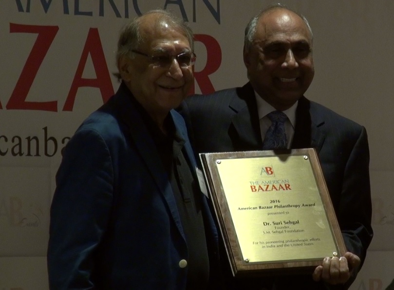 Dr. Suri Sehgal receiving the American Bazaar Philanthropy Award from Frank Islam in Washington, DC, on October 1, 2016.