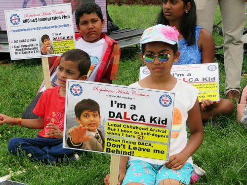 An Indian DALCA kid holds a sign at an immigration rally on Capitol Hill asking US lawmakers to include protections for legal Dreamers in any immigration reform legislation