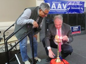 Sen. Tim Kaine lighting the “diya” (lamp) at a Diwali celebration co-hosted by Democratic Asian Americans of Virginia (DAAV) and Virginia's 11th Congressional District Democratic Committee (CDDC). Looking on at left is Shekar Narasimhan, chairman of AAPI Victory Fund.