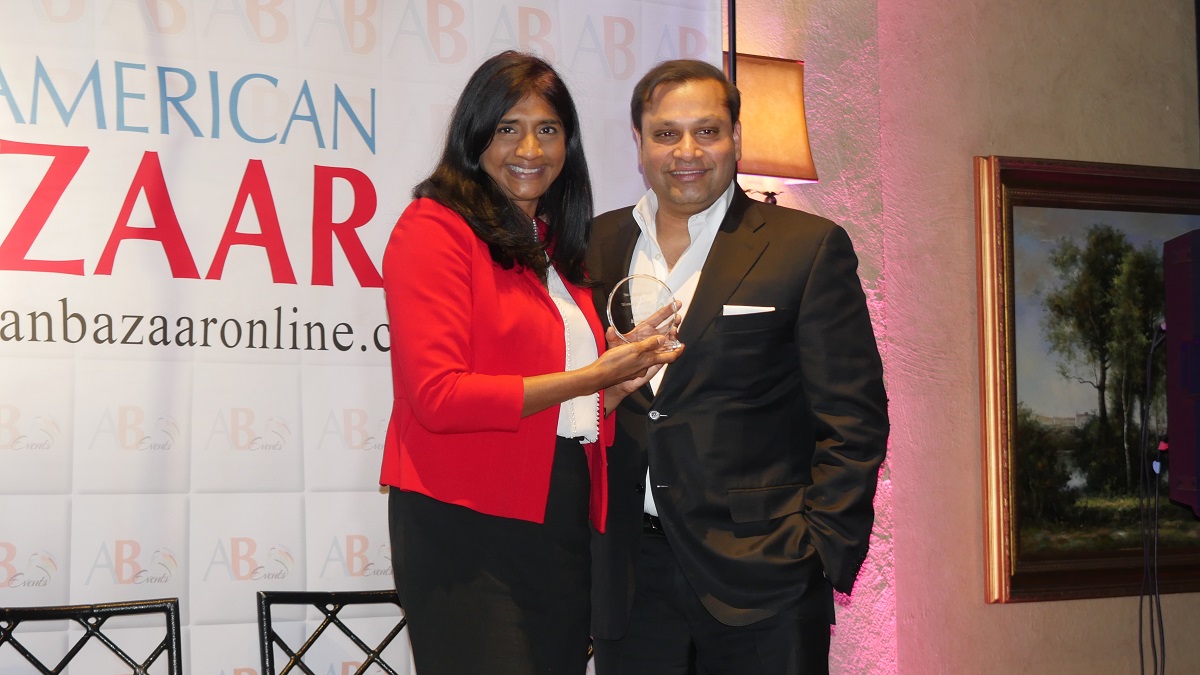 Maryland Del. Aruna Miller accepting Woman Leader of the Year award from Reggie Aggarwal, Founder and CEO of Cvent, at the American Bazaar Women Entrepreneurs and Leaders Gala in Bethesda, MD, on November 16, 2018.