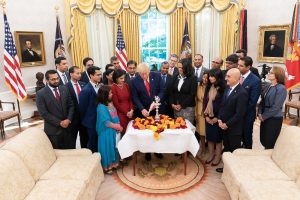 President Donald Trump lighting the Diwali 'diya' in the Oval Office, surrounded primarily by Indian-Americans serving in his administration. It is the third consecutive year that the president has celebrated the popular Indian festival of lights in the White House.