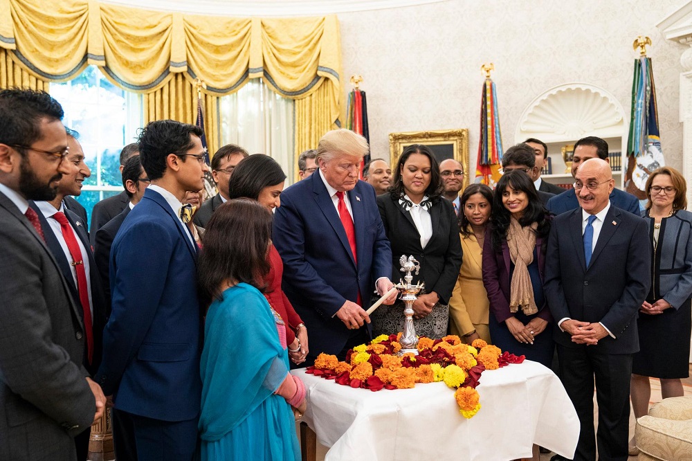 President Donald Trump lights a Diwali 'diya' (lamp) in the Oval Office surrounded by Indian-Americans serving in his administration. Official White House Photo by Joyce N. Boghosian; October 24, 2019