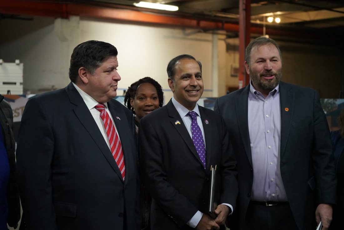 Illinois Democrat Raja Krishnamoorthi (center) with Gov. J.B. Pritzker in at an event, in Chicago on April 18, where a $3 million investment in a new training and development center in the city's South Loop neighborhood was announced. American Bazaar photo by Saju Varghese